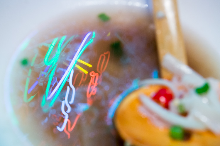 Neon reflected in the soup